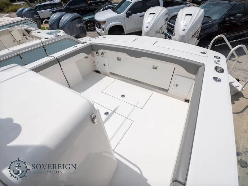 Slide: The Image of 2023 Regulator 34 boat deck with storage compartments and seating, Sovereign Yachts logo. - 30