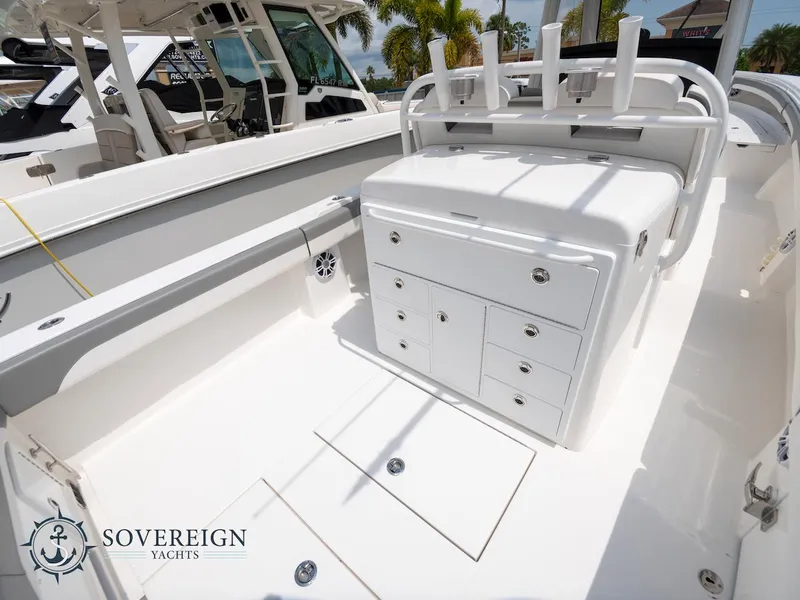 Slide: The Image of 2023 Regulator 34 yacht interior with storage compartments and rod holders. Sovereign Yachts logo visible. - 32