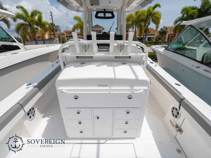 Slide: The Image of 2023 Regulator 34 boat interior with storage compartments and rod holders. Sovereign Yachts logo. - 33