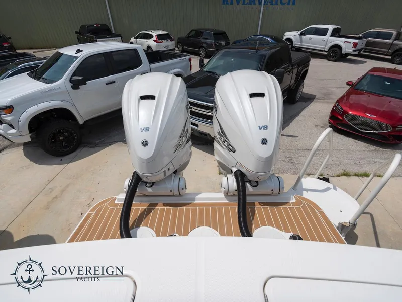 Slide: The Image of 2023 Regulator 34 boat with twin V8 engines at Sovereign Yachts dealership. - 35