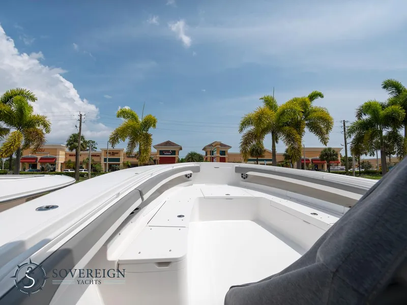 Slide: The Image of 2023 Regulator 34 boat deck with palm trees and buildings in the background. - 41