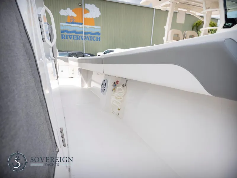 Slide: The Image of 2023 Regulator 34 boat interior with Sovereign Yachts logo and Riverwatch mural in background. - 43