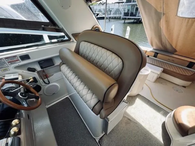 Slide: The Image of 2001 Sea Ray 340 AJ boat interior with helm seat and steering wheel. - 10