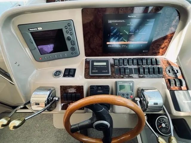 Slide: The Image of 2001 Sea Ray 340 AJ boat helm with navigation and control systems. - 12
