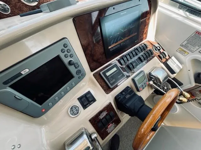 Slide: The Image of 2001 Sea Ray 340 AJ boat dashboard with navigation and control systems. - 14