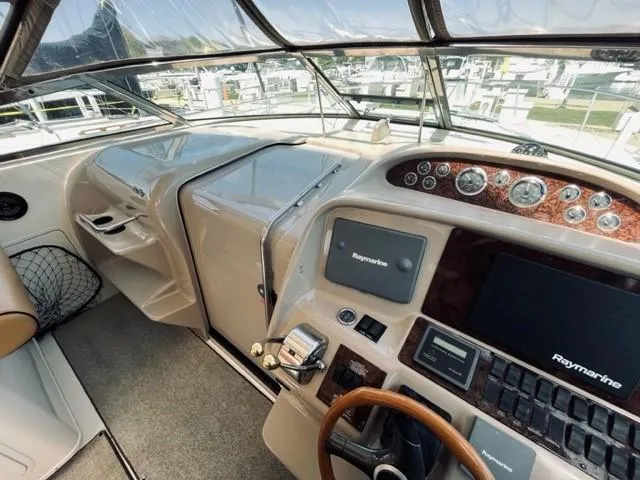 Slide: The Image of 2001 Sea Ray 340 AJ helm with Raymarine electronics and woodgrain dashboard. - 15