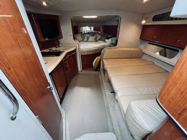 Slide: The Image of 2001 Sea Ray 340 AJ interior with kitchen, seating, and sleeping area. - 16