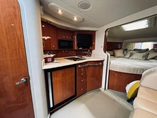 Slide: The Image of 2001 Sea Ray 340 AJ interior with kitchen and sleeping area. - 17