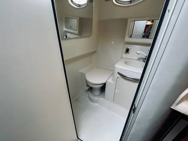 Slide: The Image of 2001 Sea Ray 340 AJ boat bathroom with toilet, sink, and mirror. - 18