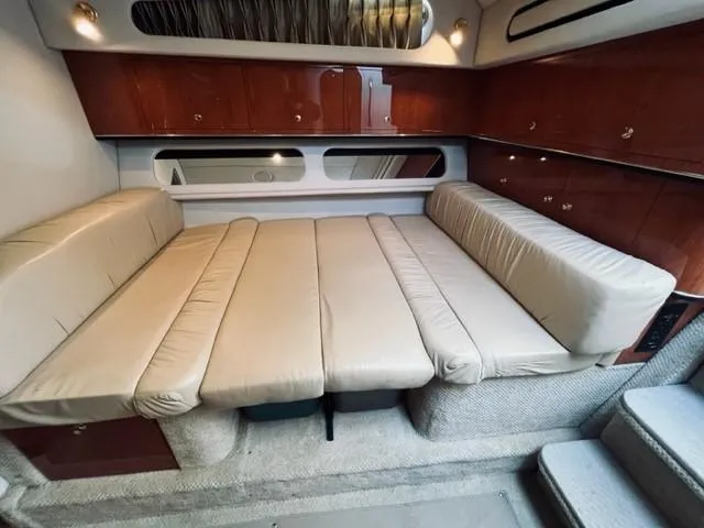 Slide: The Image of 2001 Sea Ray 340 AJ cabin interior with beige leather seating and wooden cabinetry. - 19