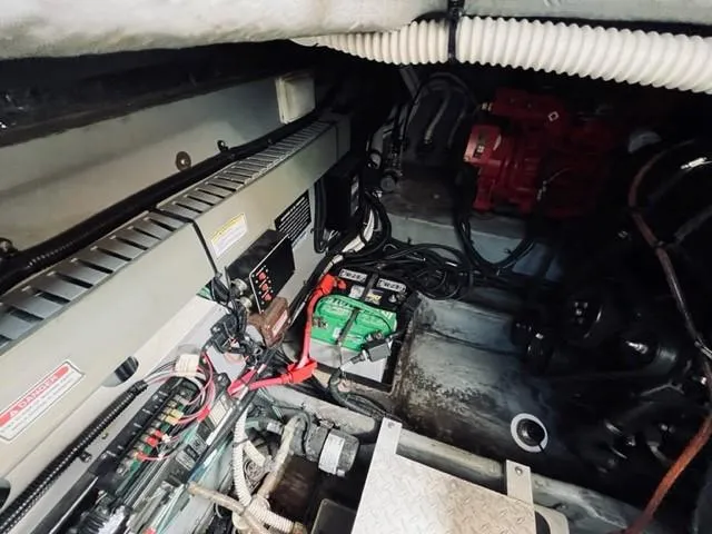 Slide: The Image of Engine compartment of a 2001 Sea Ray 340 AJ boat with visible battery and wiring. - 29