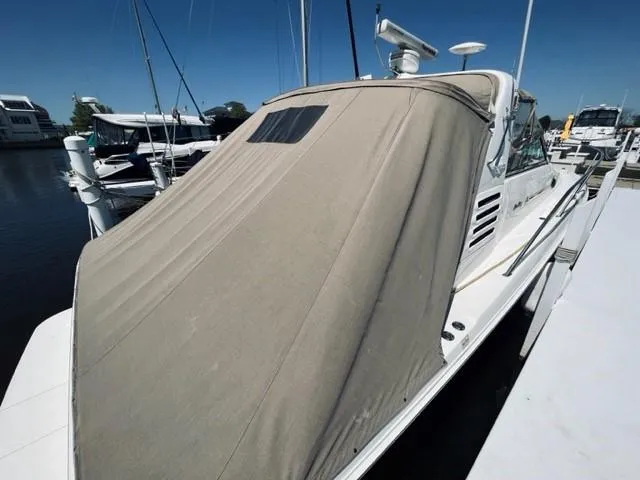 Slide: The Image of 2001 Sea Ray 340 AJ boat with cover docked at marina. - 9