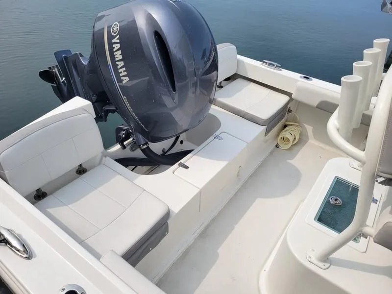 Slide: The Image of 2023 Parker 2100 SE boat with Yamaha outboard motor, white seating, and rod holders. - 3