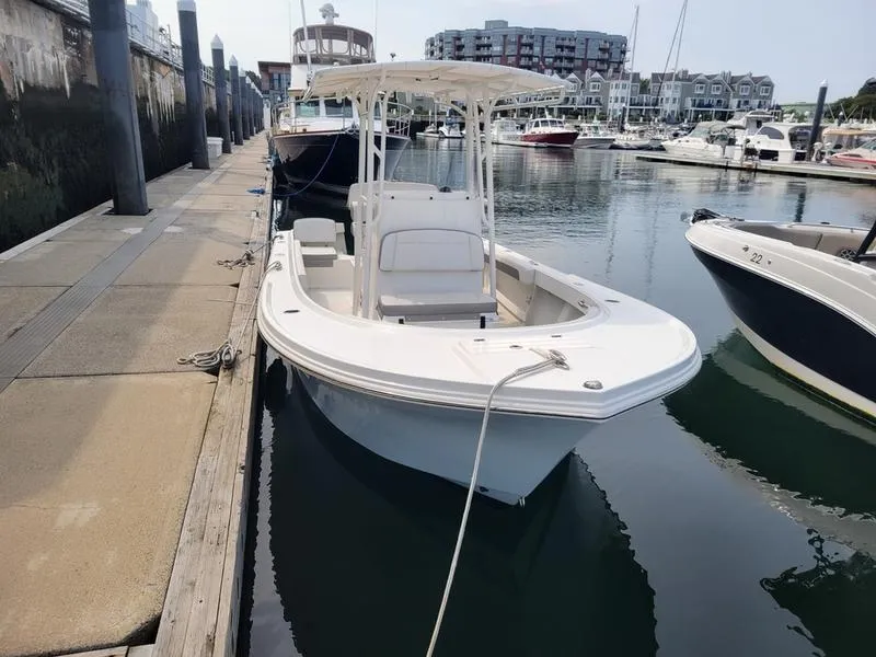 Slide: The Image of 2023 Parker 2100 SE boat docked in marina, surrounded by other vessels. - 4