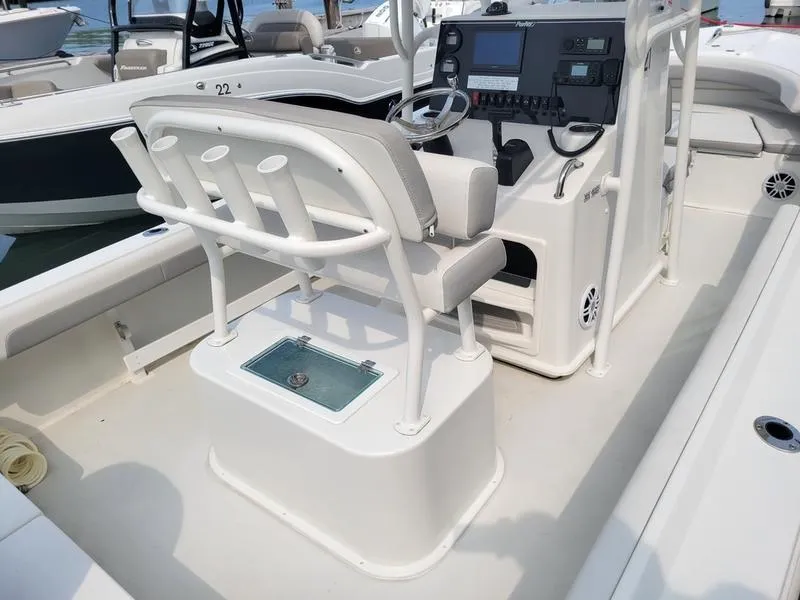 Slide: The Image of 2023 Parker 2100 SE boat interior with helm and seating area. - 6