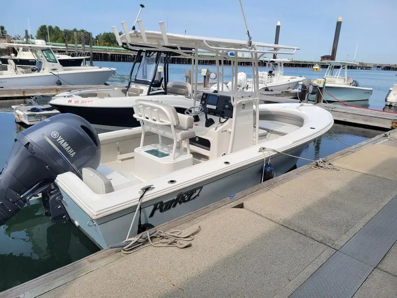 Slide: The Image of 2023 Parker 2100 SE boat docked with Yamaha outboard motor. - 9