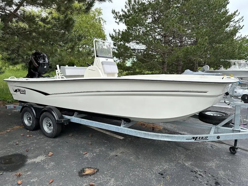 Slide: The Image of 2023 Mako SKIFF 19 CC boat on trailer, parked outdoors. - 0