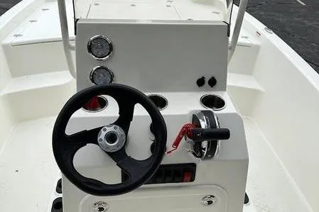 Slide: The Image of 2023 Mako SKIFF 19 CC boat console with steering wheel and controls. - 1