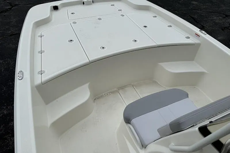 Slide: The Image of 2023 Mako SKIFF 19 CC boat interior with seating and storage compartments. - 14