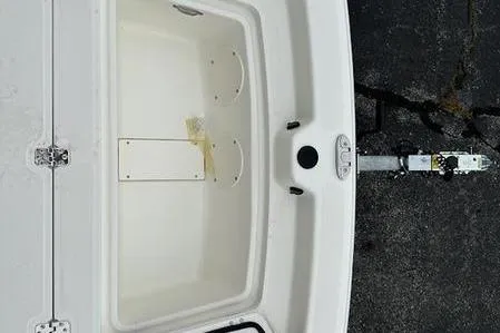 Slide: The Image of 2023 Mako SKIFF 19 CC boat interior with storage compartment and trailer hitch. - 15