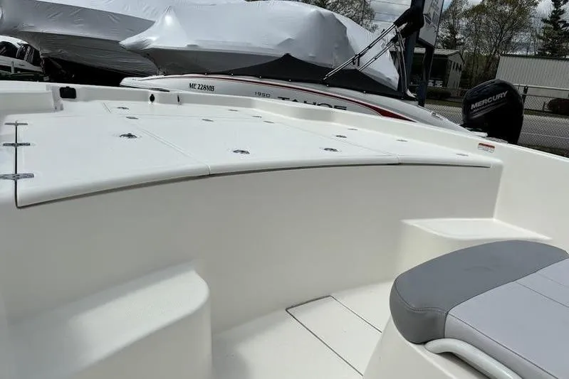 Slide: The Image of 2023 Mako SKIFF 19 CC boat interior with seating and storage compartments. - 17