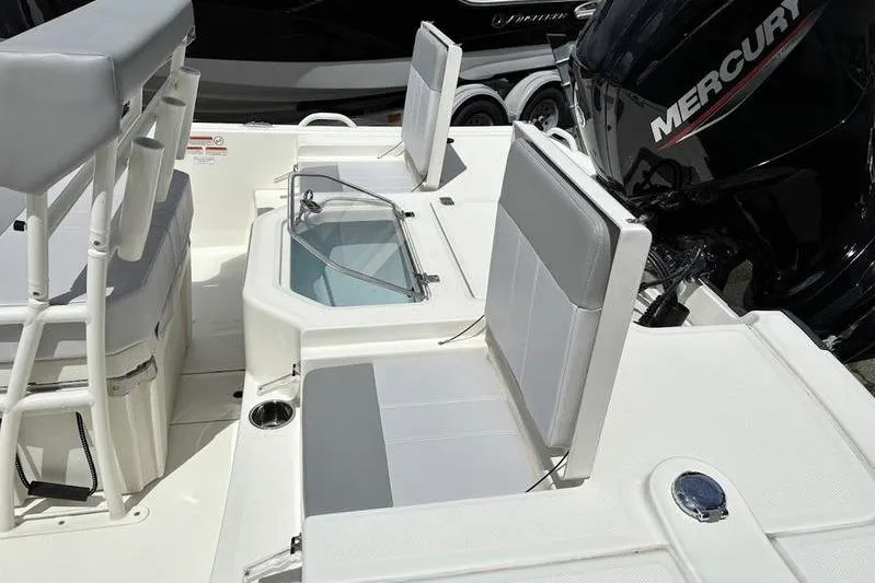 Slide: The Image of 2023 Mako SKIFF 19 CC boat interior with seating and Mercury engine. - 22