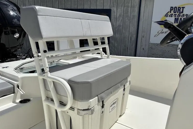 Slide: The Image of 2023 Mako SKIFF 19 CC boat interior with cushioned seating and storage. - 23