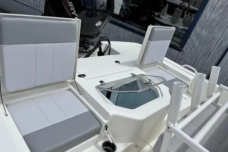 Slide: The Image of 2023 Mako SKIFF 19 CC boat interior with seating and storage compartments. - 25