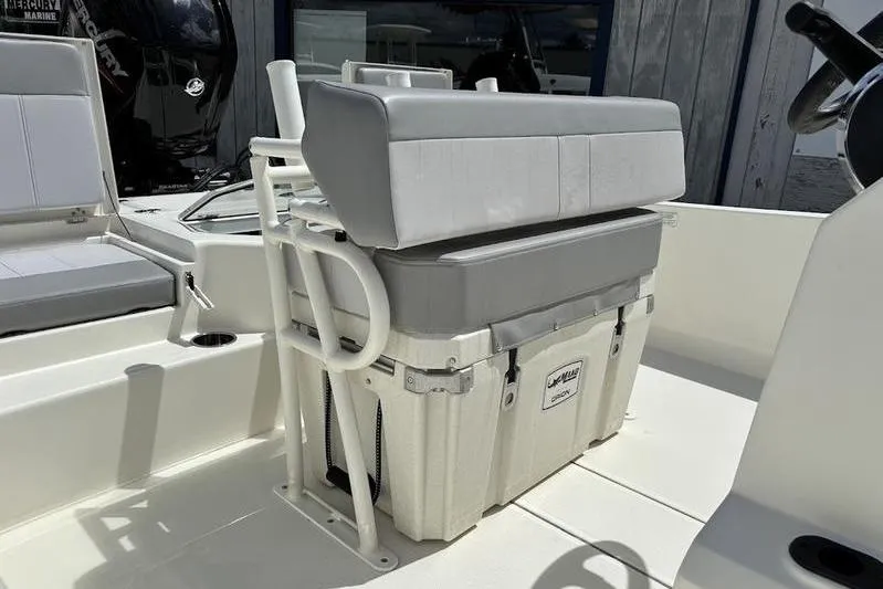 Slide: The Image of 2023 Mako SKIFF 19 CC boat interior with cushioned seating and storage. - 28