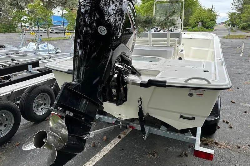 Slide: The Image of 2023 Mako SKIFF 19 CC boat with outboard motor on trailer. - 4
