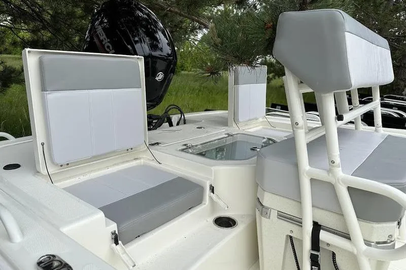 Slide: The Image of 2023 Mako SKIFF 19 CC boat interior with seating and storage compartments. - 7