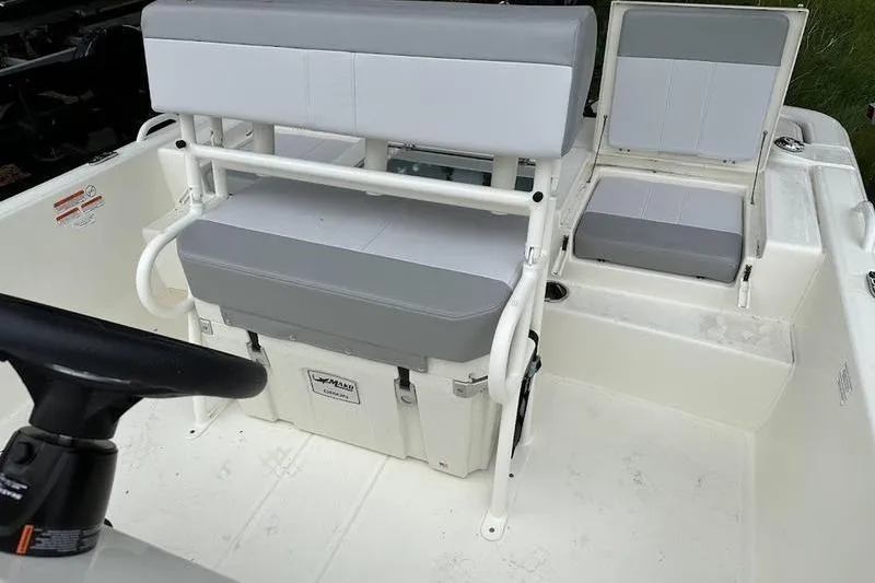 Slide: The Image of 2023 Mako SKIFF 19 CC boat interior with seating and steering wheel. - 8