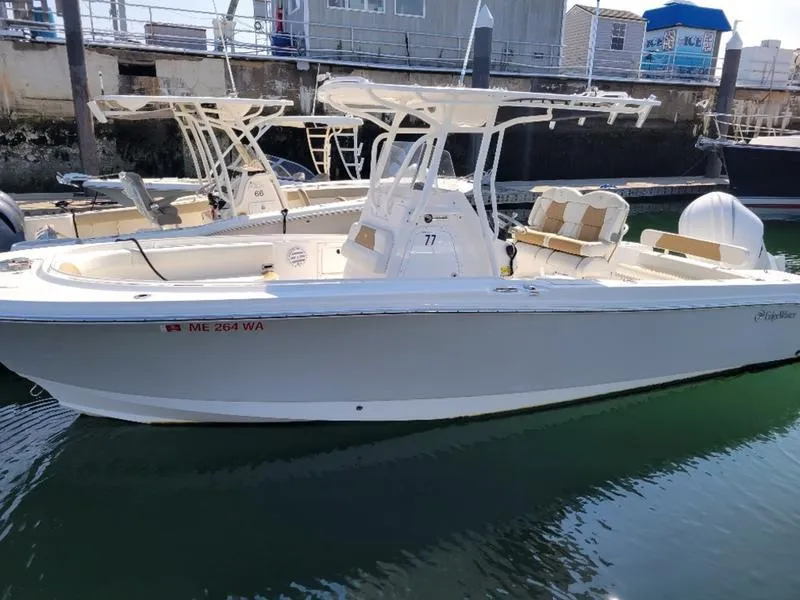 Slide: The Image of 2023 Edgewater 245 CC boat docked in marina, side view. - 13