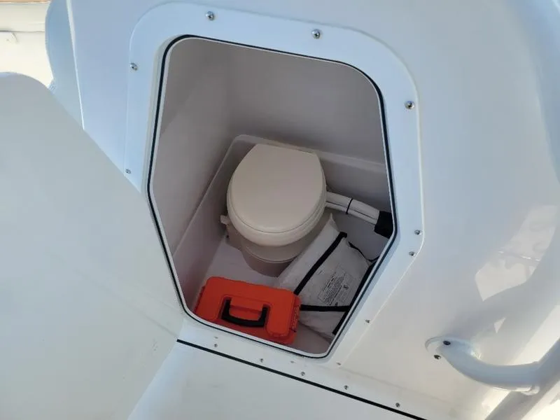 Slide: The Image of 2023 Edgewater 245 CC boat toilet compartment with storage. - 7
