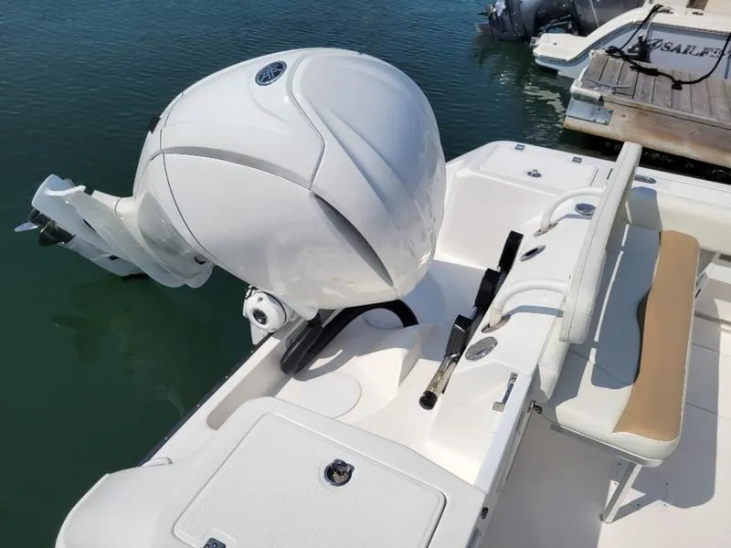 Slide: The Image of 2023 Edgewater 245 CC boat with powerful outboard motor docked. - 8