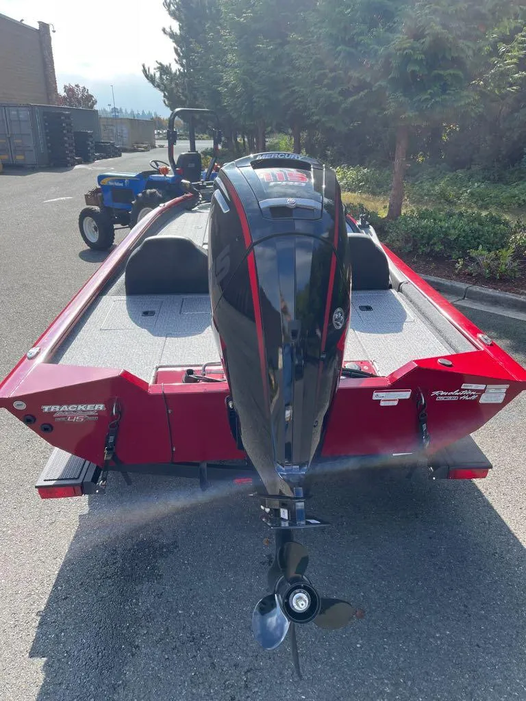 Slide: The Image of 2023 Tracker Pro Team 190 TX boat with outboard motor, parked outdoors. - 44
