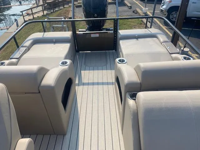 Slide: The Image of 2023 SunCatcher Fusion 324SS boat interior with beige seating and cup holders. - 11