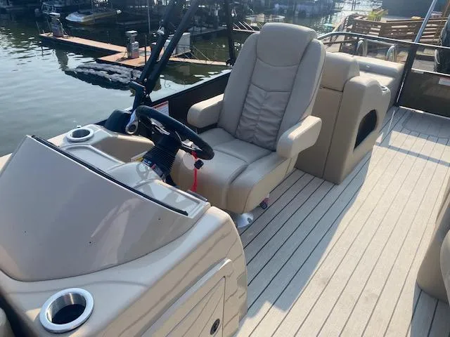 Slide: The Image of 2023 SunCatcher Fusion 324SS boat interior with captain's chair and steering console. - 12