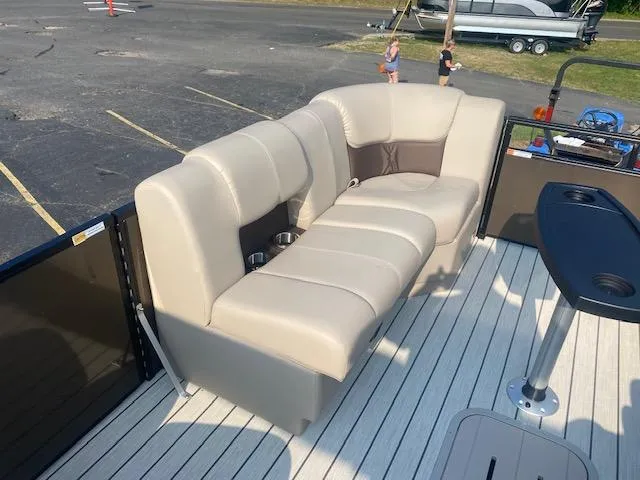 Slide: The Image of 2023 SunCatcher Fusion 324SS boat interior with beige seating and cup holders. - 14