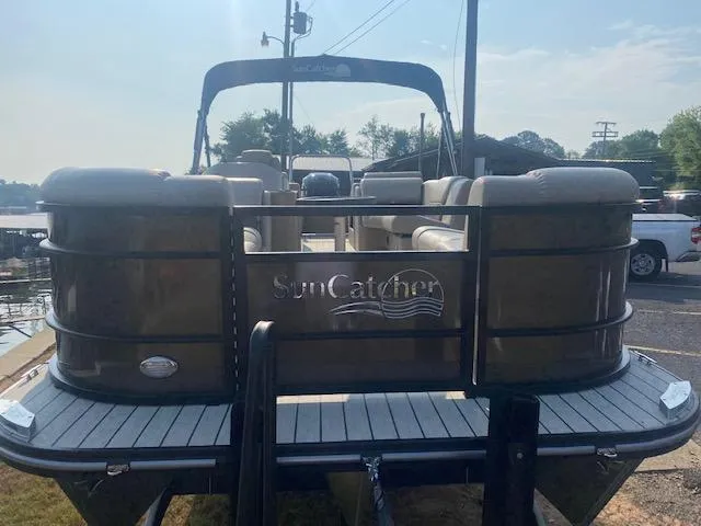 Slide: The Image of 2023 SunCatcher Fusion 324SS pontoon boat at dock, rear view. - 2