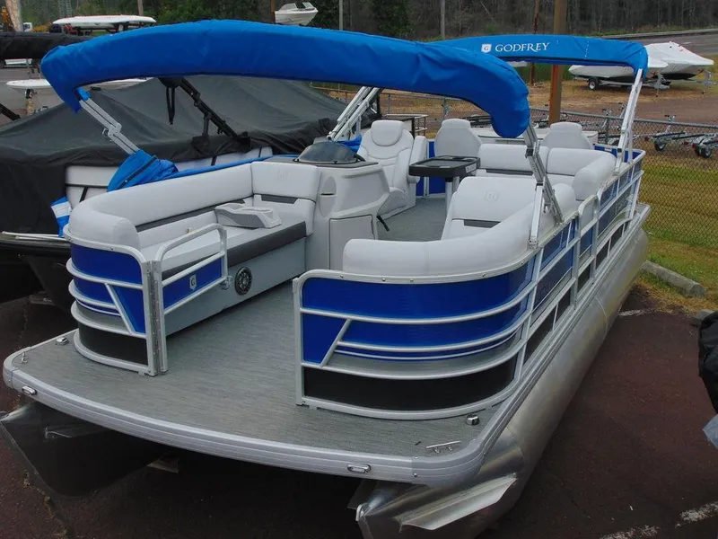Slide: The Image of 2023 Godfrey Sweetwater 2286 FS pontoon boat with blue canopy and spacious seating. - 0