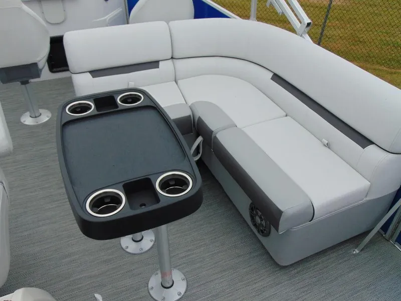Slide: The Image of 2023 Godfrey Sweetwater 2286 FS boat interior with cushioned seating and table. - 12