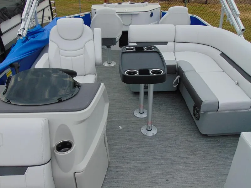 Slide: The Image of 2023 Godfrey Sweetwater 2286 FS boat interior with plush seating and table. - 14