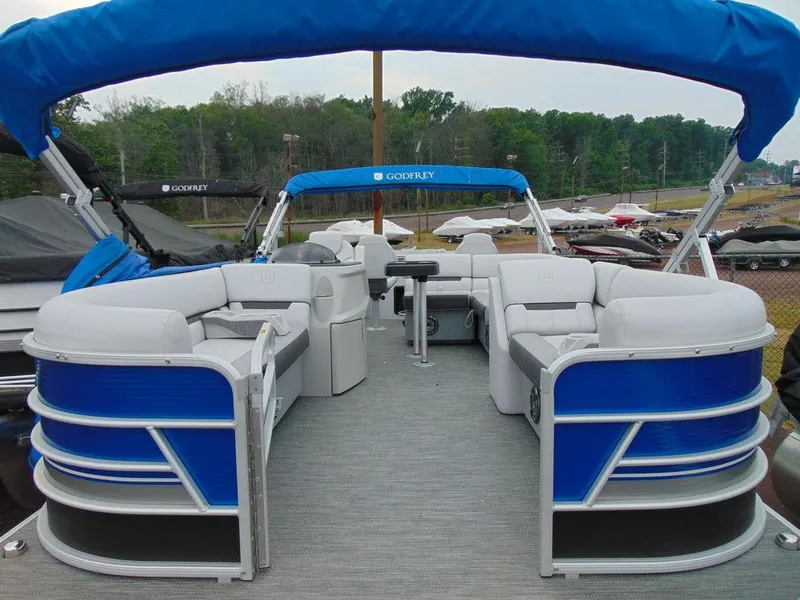 Slide: The Image of 2023 Godfrey Sweetwater 2286 FS pontoon boat with blue canopy and spacious seating. - 18