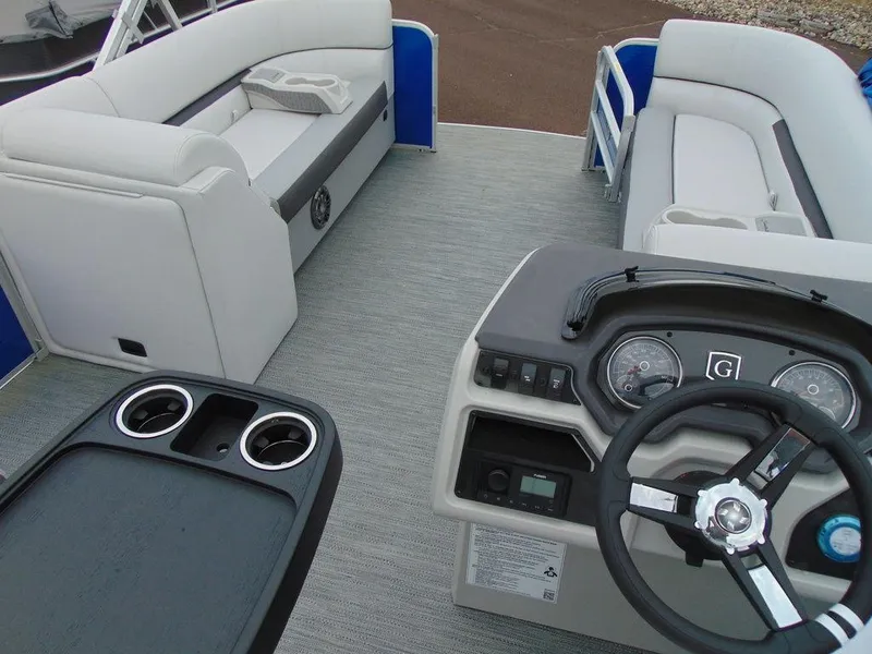 Slide: The Image of 2023 Godfrey Sweetwater 2286 FS boat interior with plush seating and modern dashboard. - 2