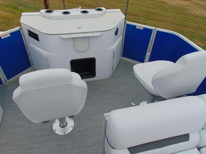 Slide: The Image of 2023 Godfrey Sweetwater 2286 FS boat interior with white seating and blue accents. - 7