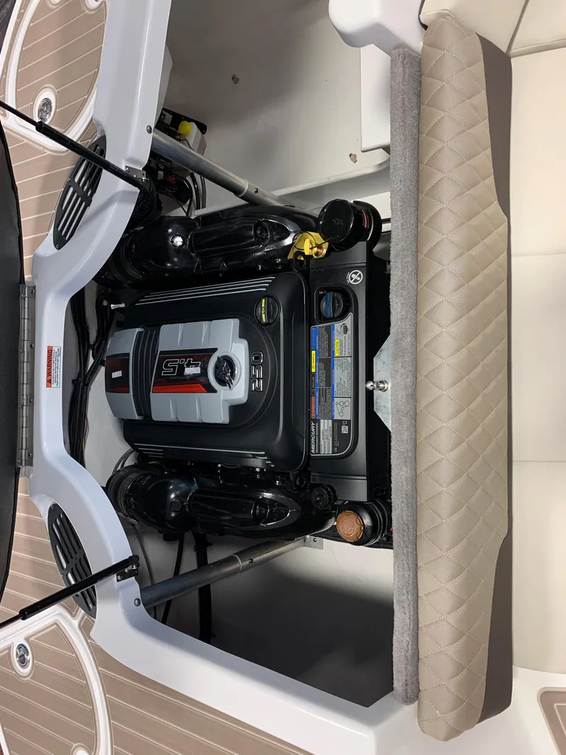 Slide: The Image of 2024 Monterey 224FS boat engine compartment with detailed view of engine components. - 10