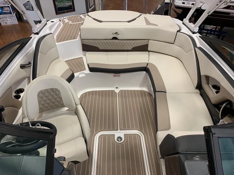 Slide: The Image of 2024 Monterey 224FS boat interior with beige seating and wood-style flooring. - 4