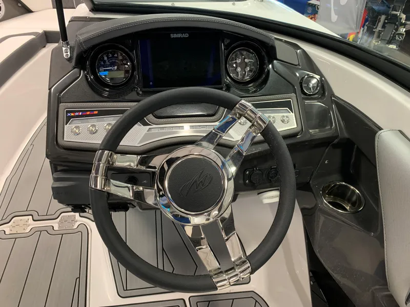 Slide: The Image of 2024 Monterey 238 Super Sport boat dashboard with steering wheel and modern controls. - 11