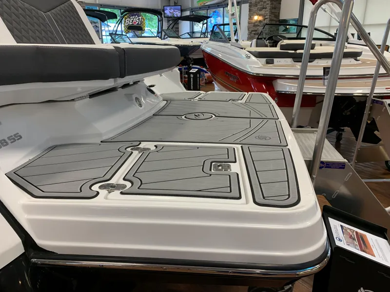 Slide: The Image of 2024 Monterey 238 Super Sport boat with sleek deck design in showroom. - 3